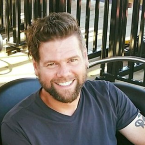 smiling man in roller coaster train