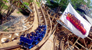 wooden roller coaster turns by flag
