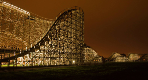 Zippin Pippin wooden roller coaster lit up at night