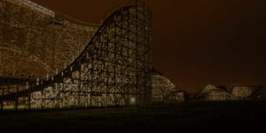 Zippin Pippin wooden roller coaster lit up at night